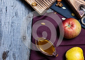 Bread fruits and jam on the scratched wooden cutting board