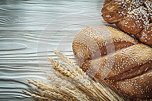 Bread golden wheat ears on white board