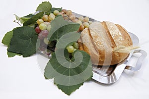 Bread and grapes with leaves on tray at Catholic Mass