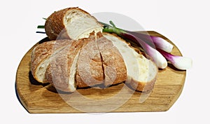 Bread and green onion on the cutting board on the white background,isolated.