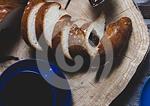 Bread and jam on the scratched wooden cutting board