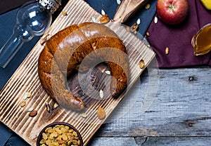 Bread and jam on the scratched wooden cutting board