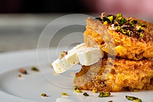 Bread kadayif or Ekmek Kadayifi with cream, a delicious Turkish dessert served in a fine dining restaurant