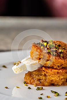 Bread kadayif or Ekmek Kadayifi with cream, a delicious Turkish dessert served in a fine dining restaurant