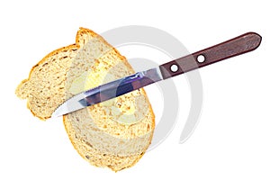 Bread knife and butter on white
