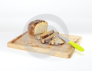 bread and knife on a wooden cutting board