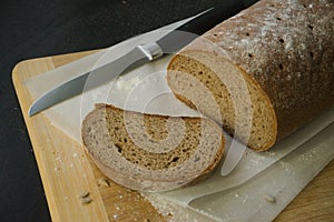 Bread with a knifeon a wood board