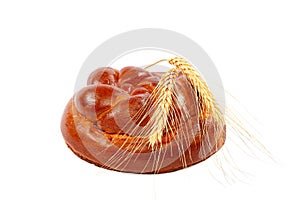 Bread loaf and wheat ear on a white background.