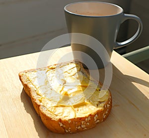 Bread with magarine topping and hot drink