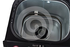 Bread maker isolated on white background. Home electronic programmable bread maker with open lid.Top view, inside heating element