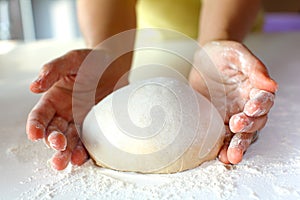 Bread making and kneading on the dusted workspace photo