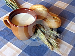 Bread, milk and wheat still-life