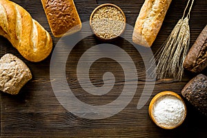 Bread near wheat ears and bowl of flour top-down space for text