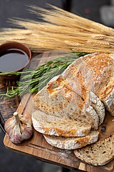 Bread, pepper, garlic, oil on a wooden table