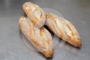 Bread pieces on a metallic kitchen surface.