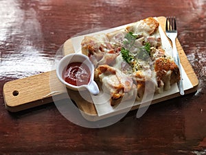 Bread pizza and ketchup on wooden tray. Delicious menu.