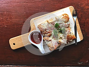 Bread pizza and ketchup on wooden tray. Delicious menu.