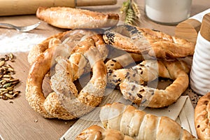 Bread, pretzels and pastry products, wheat and flour on the wooden kitchen table