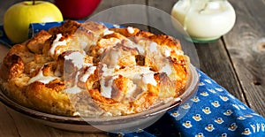 Bread pudding. Traditional English breakfast casserole with apples and vanilla sauce. Bread and butter pudding on old wooden