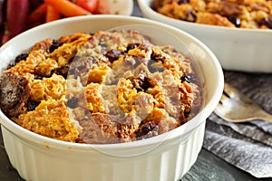 Bread pudding in a white ramekin close up