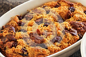 Bread pudding in a white ramekin close up