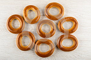 Bread rings baranka scattered on wooden table. Top view photo