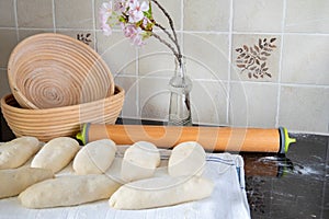 Bread rising on towel, bread baskets, pin