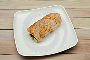 Bread sandwich with square and white plate