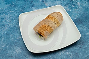 Bread sandwich with square and white plate