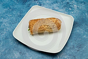 Bread sandwich with square and white plate