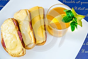 Bread with sausage and cheese and tea