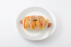 Bread sausage roll  on plate on white background