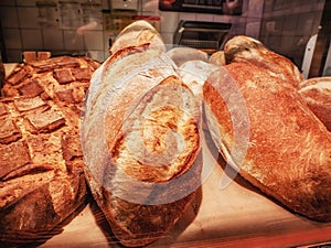 Bread on a shelf in a bakery close-up on a dark background