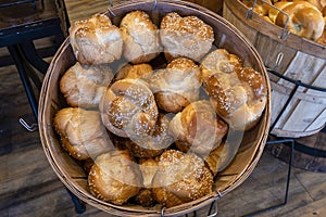 Bread on the shelf in the bakery on wooden basket.