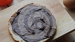 Bread slice with chocolate cream, yummy breakfast, high carbs sugar and calories food