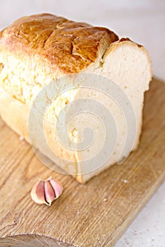 Bread slice and garlic and wooden table