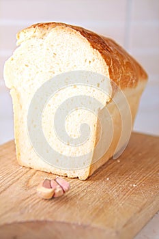 Bread slice and garlic and wooden table