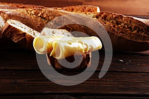 Bread with slices of cheese for lunch table. Sharing antipasti on party or summer picnic time over wooden rustic background