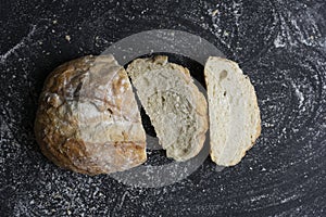 Bread slices on floury black background