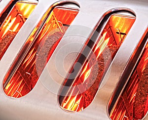 Bread slices toasting in toaster photo