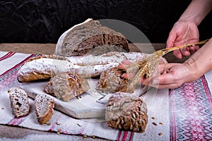 Bread and spikelets are held by hands photo