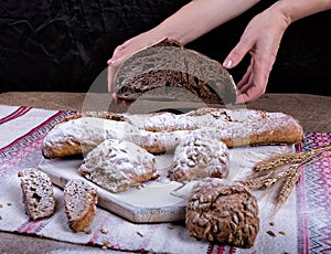 Bread and spikelets are held by hands photo