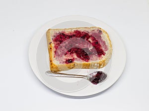 Bread with spread jam on the wooden dish