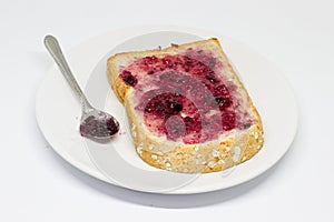 Bread with spread jam on the wooden dish