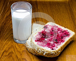 Bread with spread jam on the wooden dish