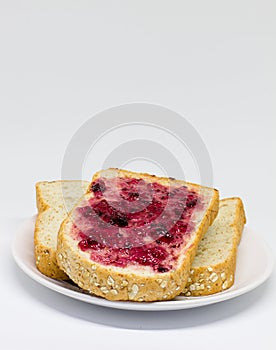 Bread with spread jam on the wooden dish
