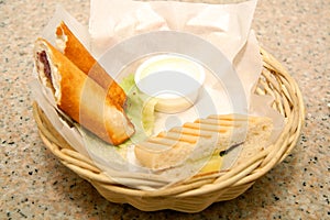 Bread stick and clubhouse sandwich on basket