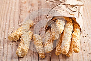 Bread sticks grissini with sesame seeds in craft pack