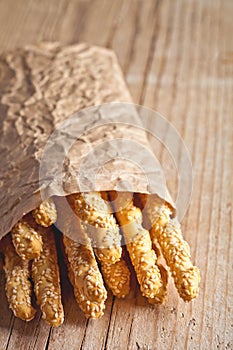 Bread sticks grissini with sesame seeds in craft pack
