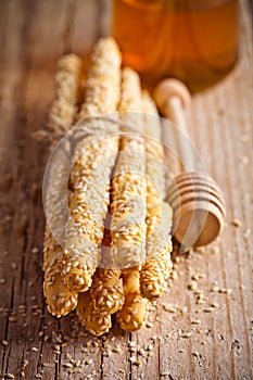 Bread sticks grissini with sesame seeds and honey